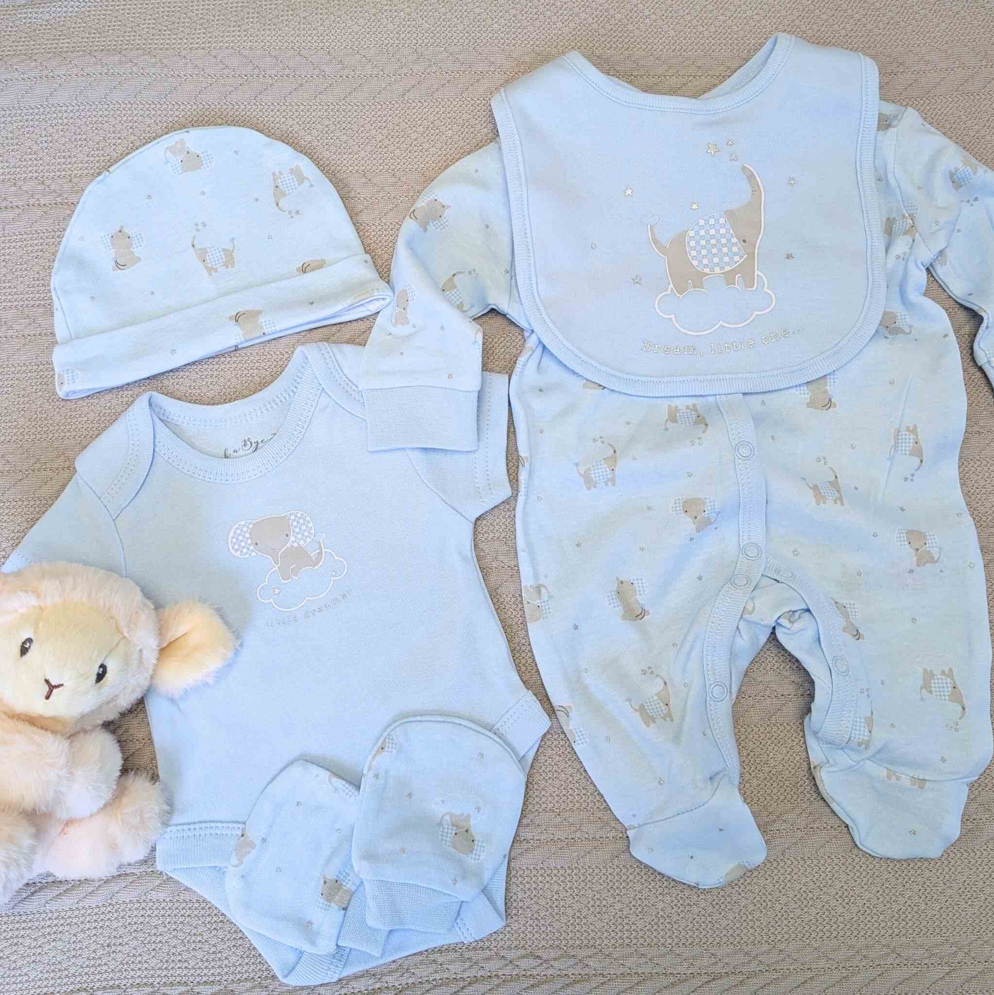 Blue baby boy clothing with elephant design includes, hat, bib, mittens, vest and sleepsuit.