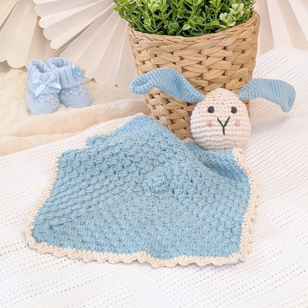 Crocheted blue bunny baby comforter soft toy.