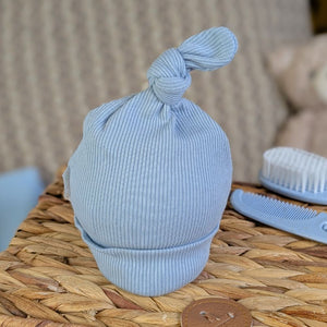 Dusky blue baby knot hat made from recycled materials.