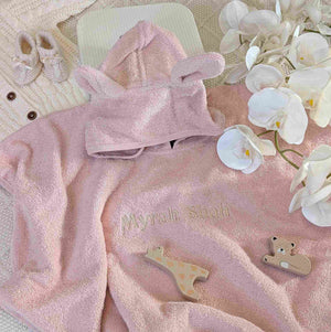 Dusky pink towelling baby poncho with embroidered name.