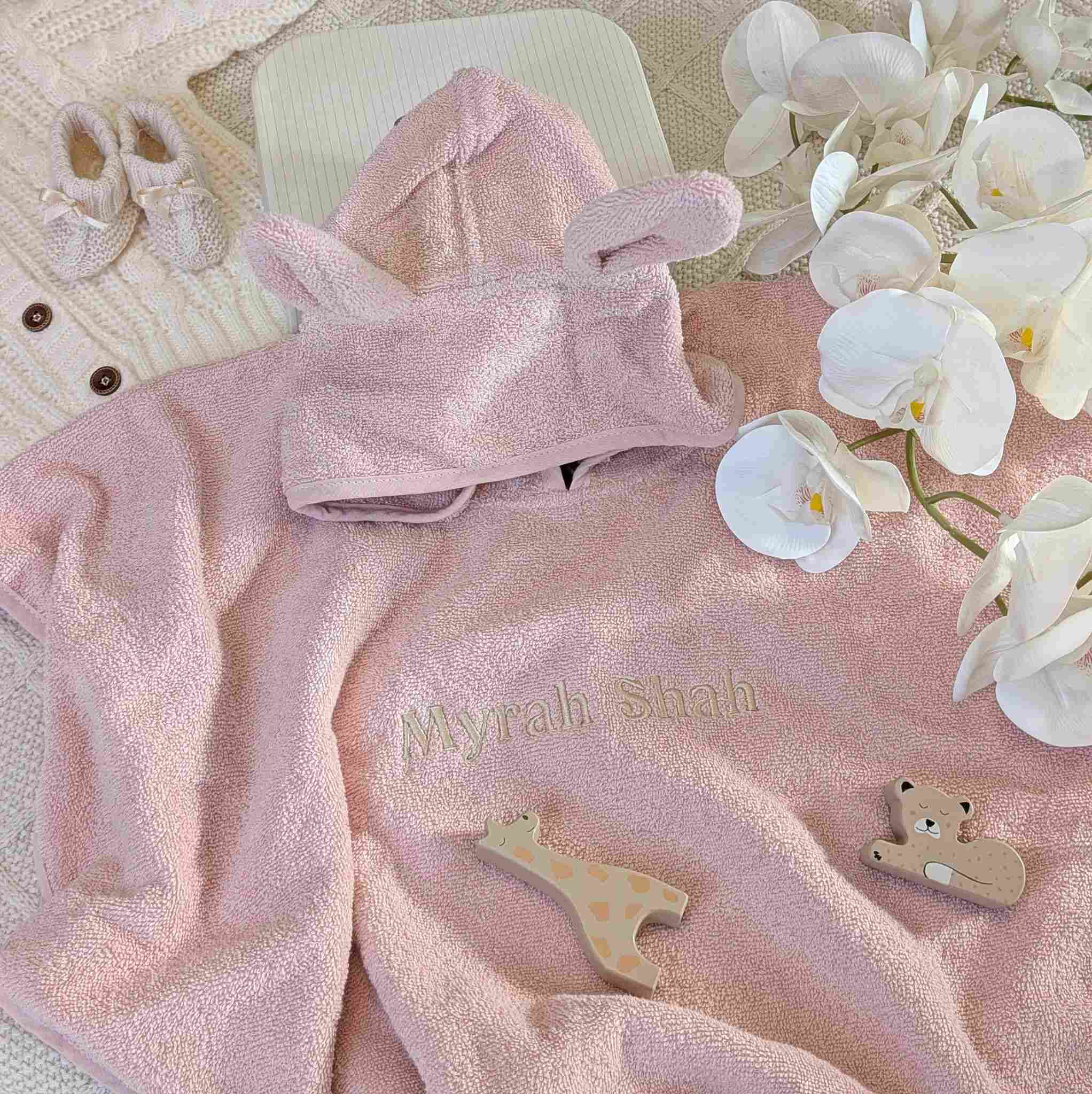 Dusky pink towelling baby poncho with embroidered name.