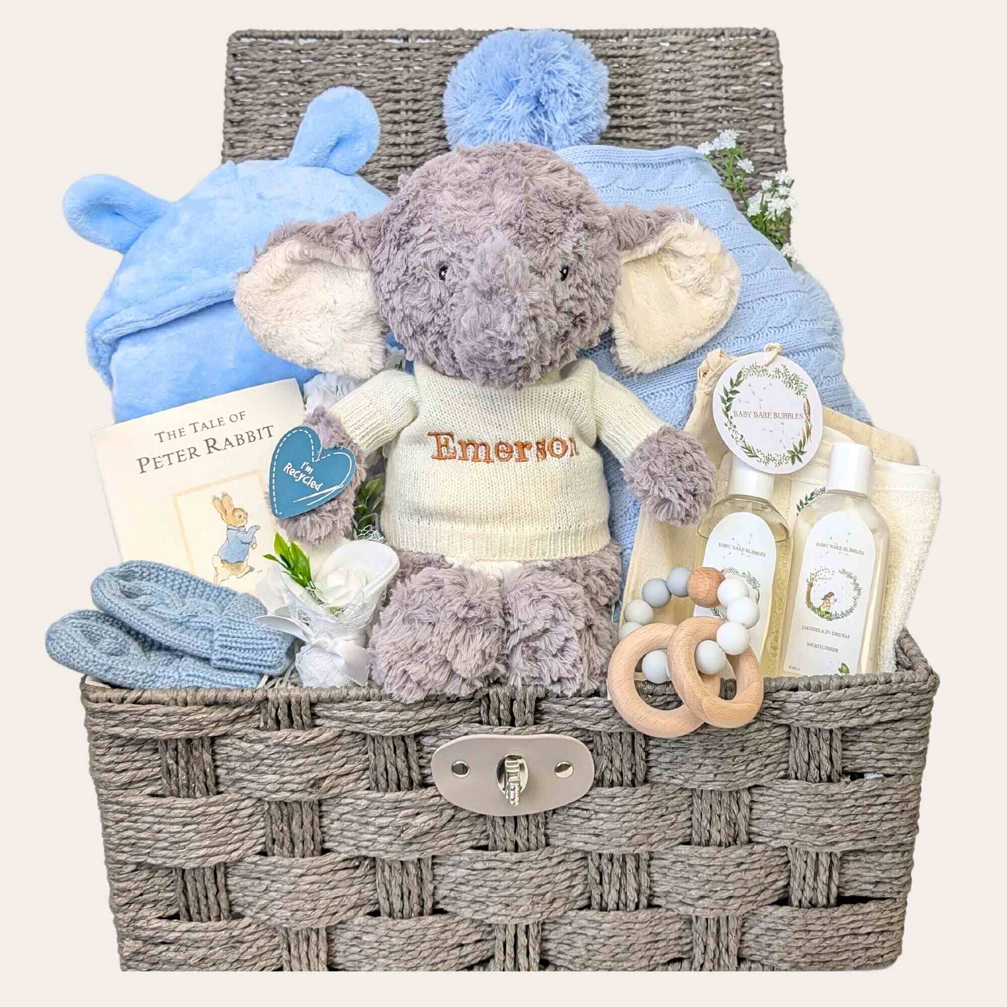 New baby boys hamper basket with gifts including personalised elephant soft toy and blue newborn presents.