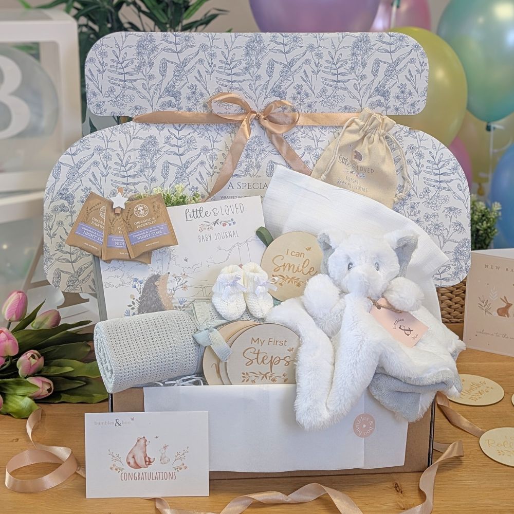 Neutral baby gifts hamper with elephant comforter, muslin, journal and tea.