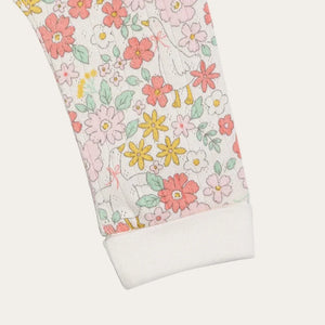 Floral-patterned fabric with pink, yellow, and green flowers on a white background