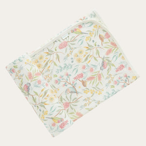 Folded flowery garden organic cotton baby swaddle blanket with Australian flora and fauna print and bound edges. 100cm x 90cm.