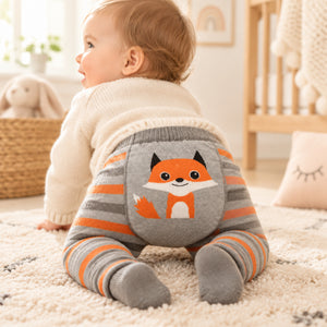 Baby wearing grey and orange striped knit leggings with a fox motif on the seat
