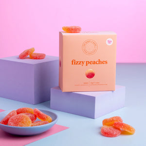 Gourmet fizzy peach sweets with sugar coating