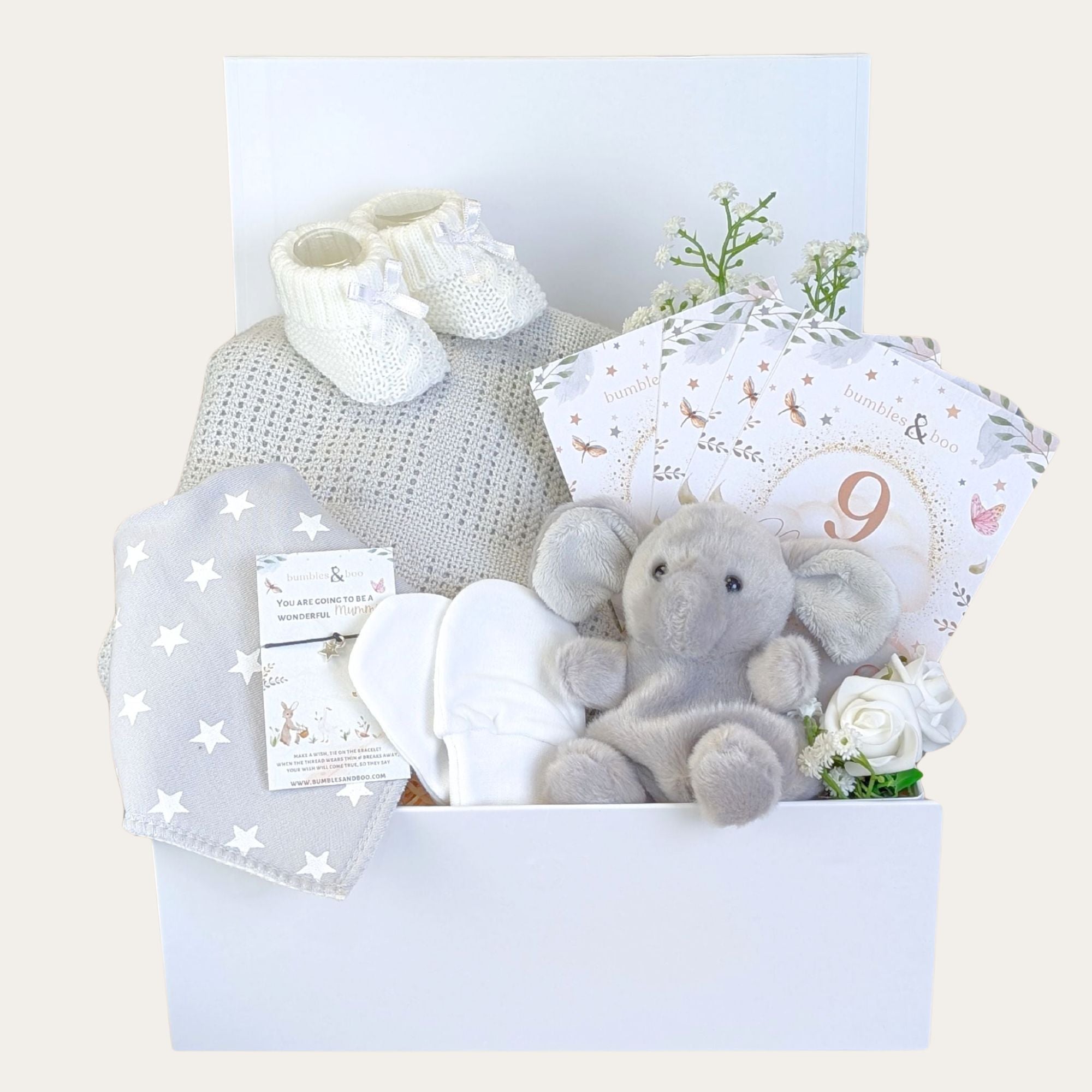 White and grey baby box hamper with a sweet elephant soft toy and blanket. Bumbles and Boo.