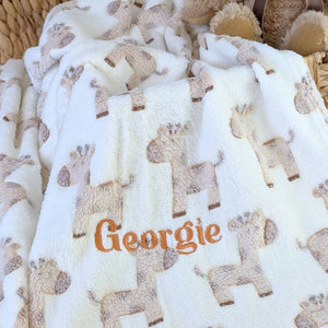 soft and fluffy giraffe baby blanket in beige.