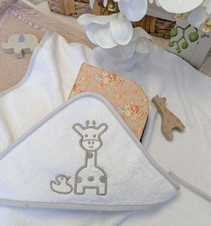 White hooded baby bath towel with a giraffe design.