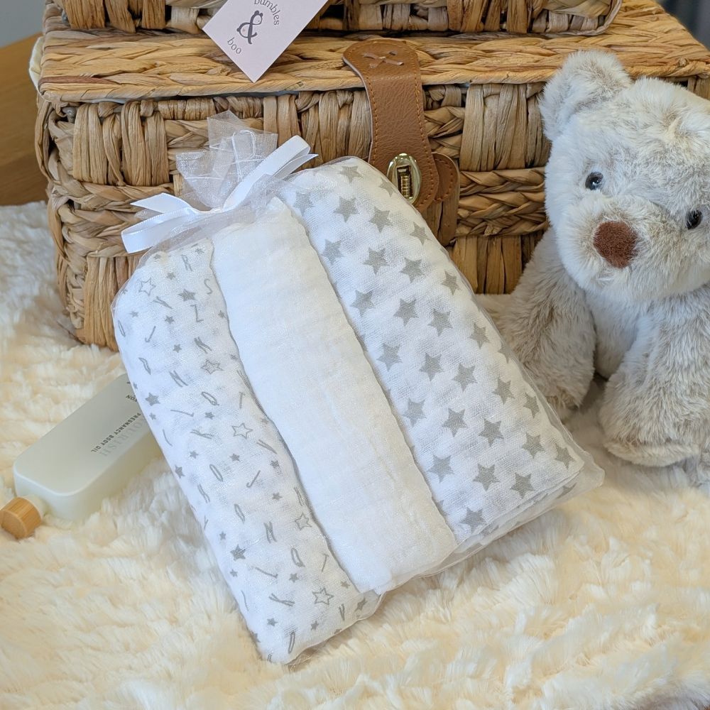 White and grey baby muslin squares made from soft cotton.