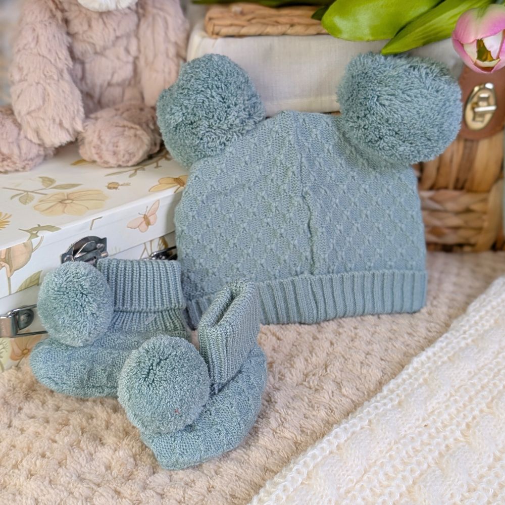 Sage green matching pompom hat and bootees set.