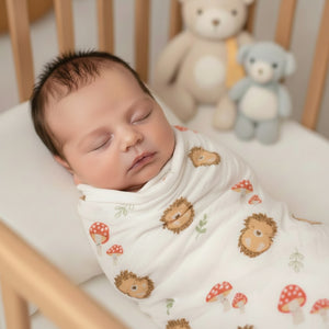 Woodland hedgehog baby muslin swaddle fabric with mushroom print on soft cotton muslin blanket.
