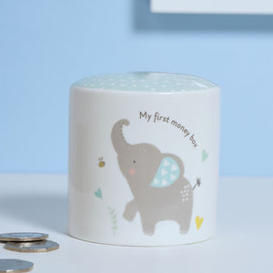 Children's money box with elephant design and text 'My first money box' on a light blue background.