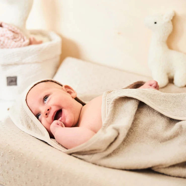 Cream Terry towelling baby towel for bath time.