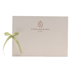 Back cover of the record book showing Little Roglets lettering and the tied green ribbon.