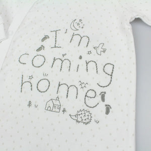 White cotton baby sleepsuit with I’m Coming Home text
