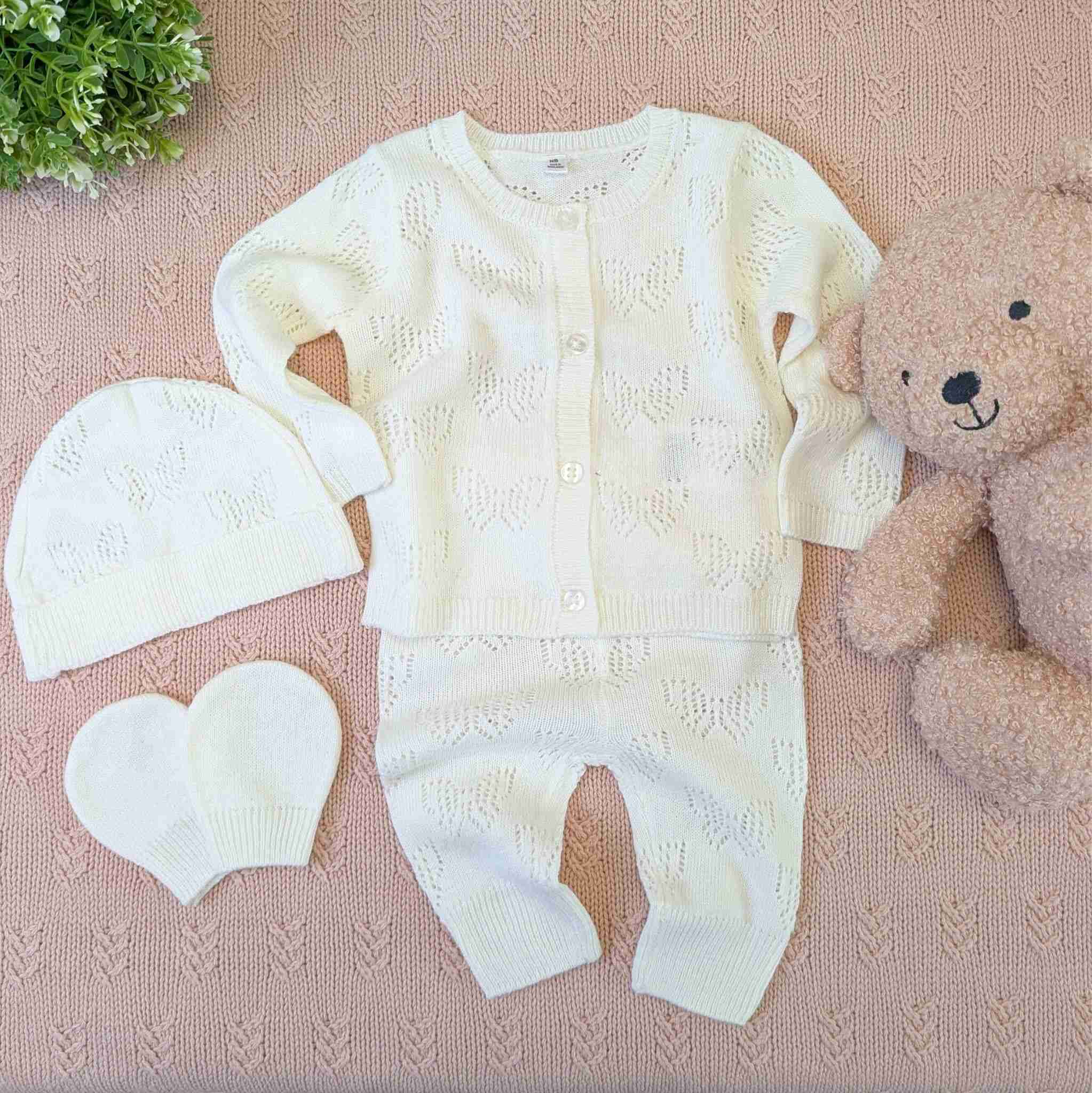 Knitted baby girl gift set with cardigan, trousers, hat and mittens.