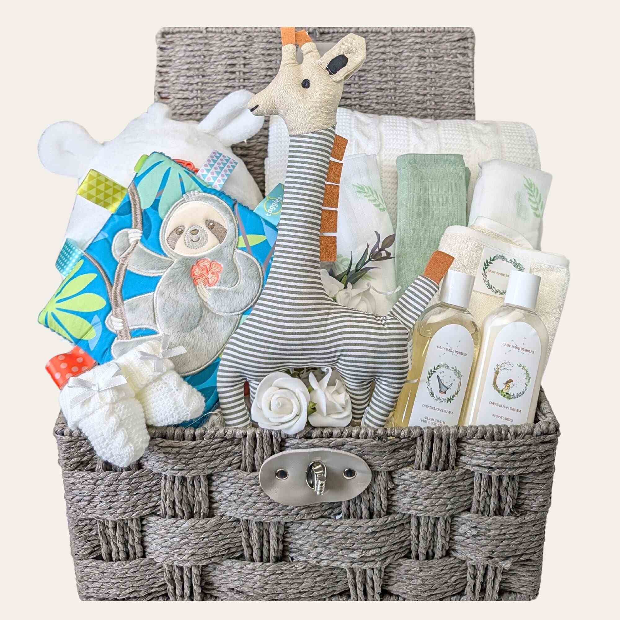 unisex baby hamper which includes baby bath robe baby knit blanket, set of muslins, organic skincare and some baby toys. Bumbles and Boo.