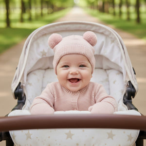 Baby girl wearing katie loxton pink knot hat and mittens set