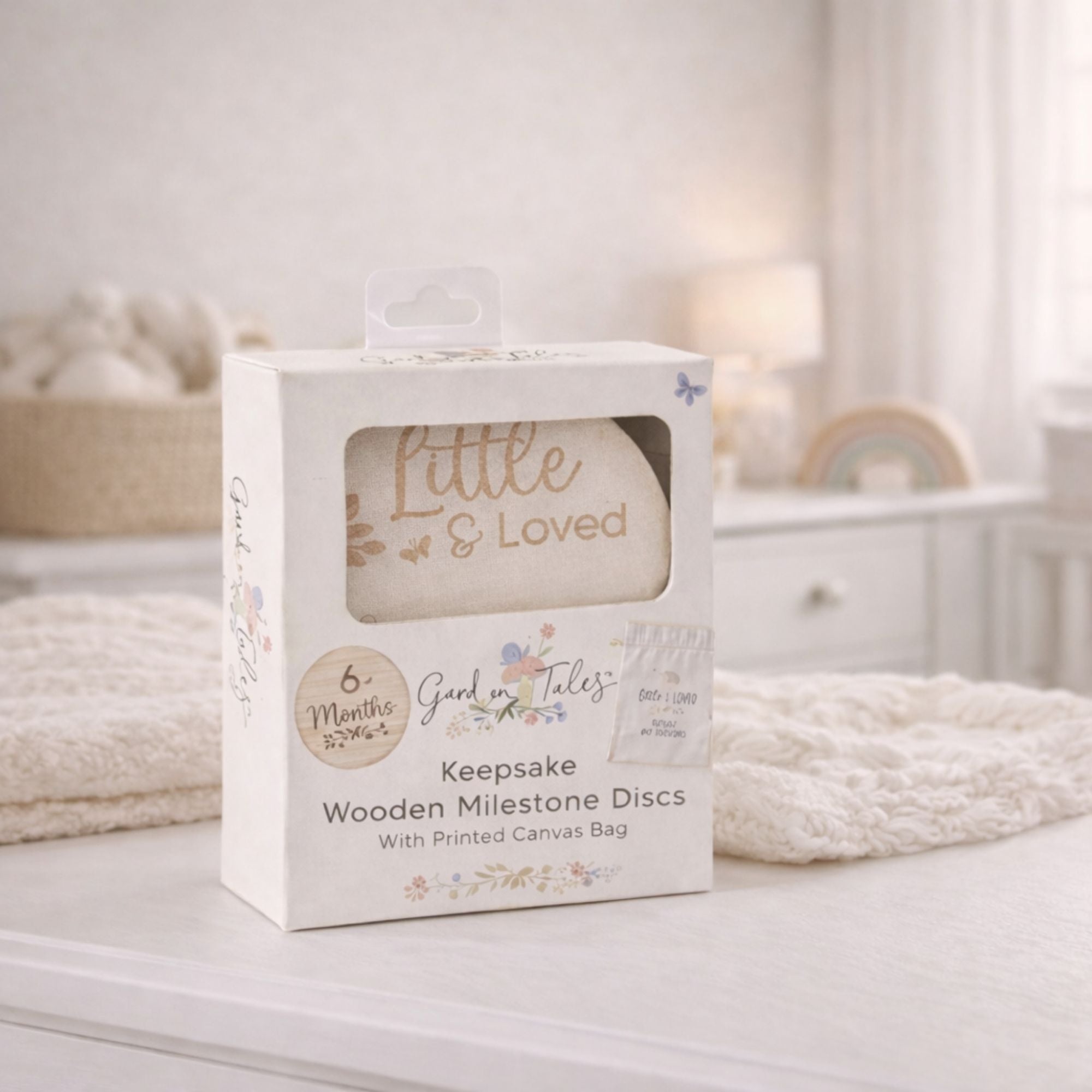 Box of 'Little & Loved' keepsake wooden milestone discs for a baby