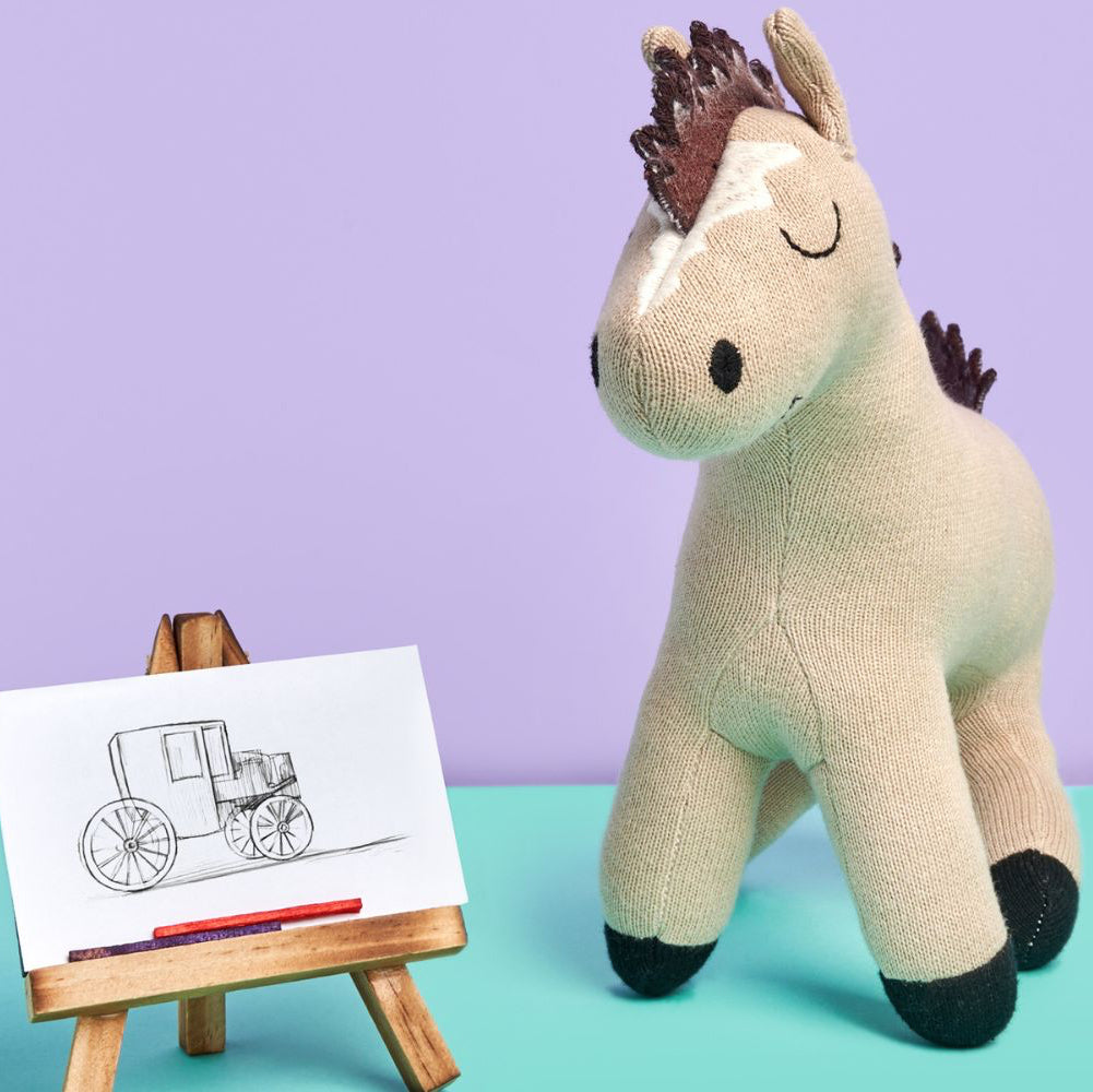 Knitted organic cotton horse soft toy for babies, featuring a neutral farm animal design made for cuddles and imaginative play