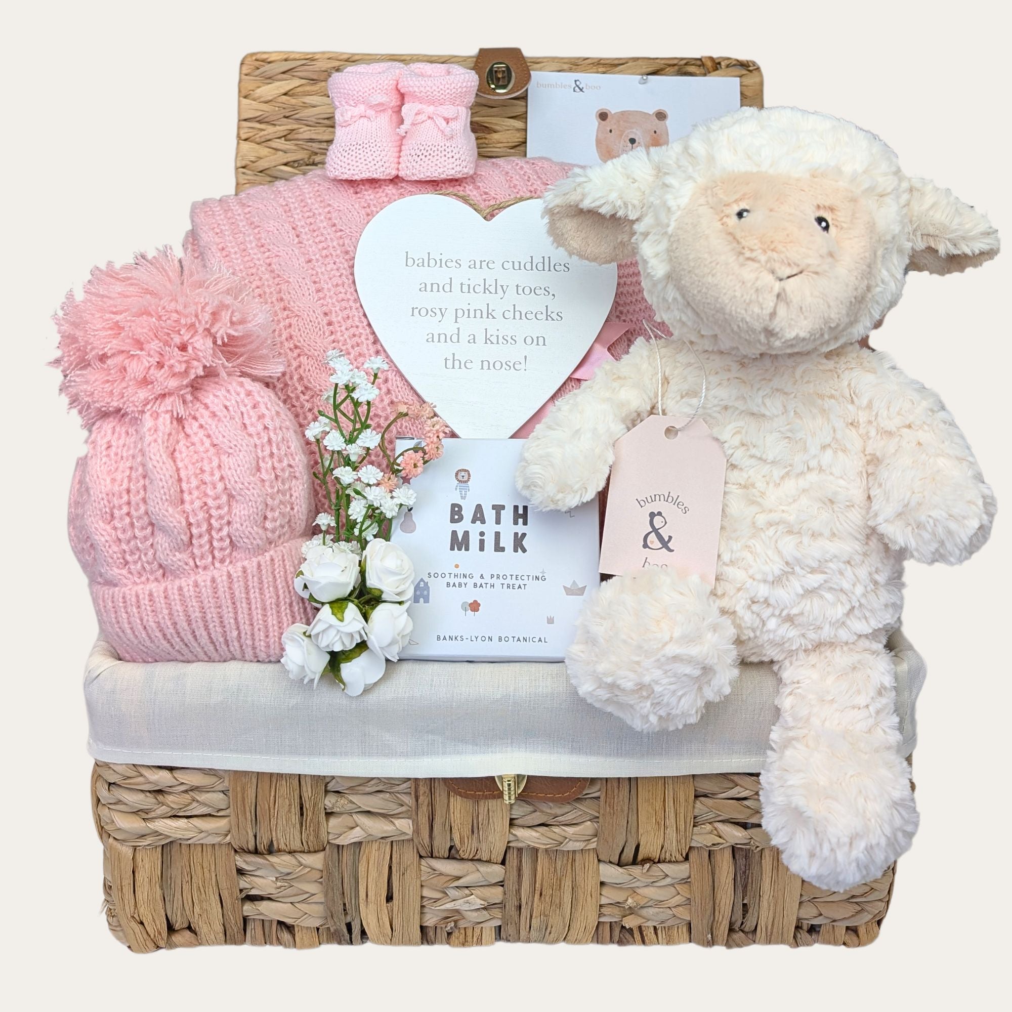 New baby girl hamper basket with lamb soft toy and gifts including organic skincare and blanket by Bumbles and Boo.