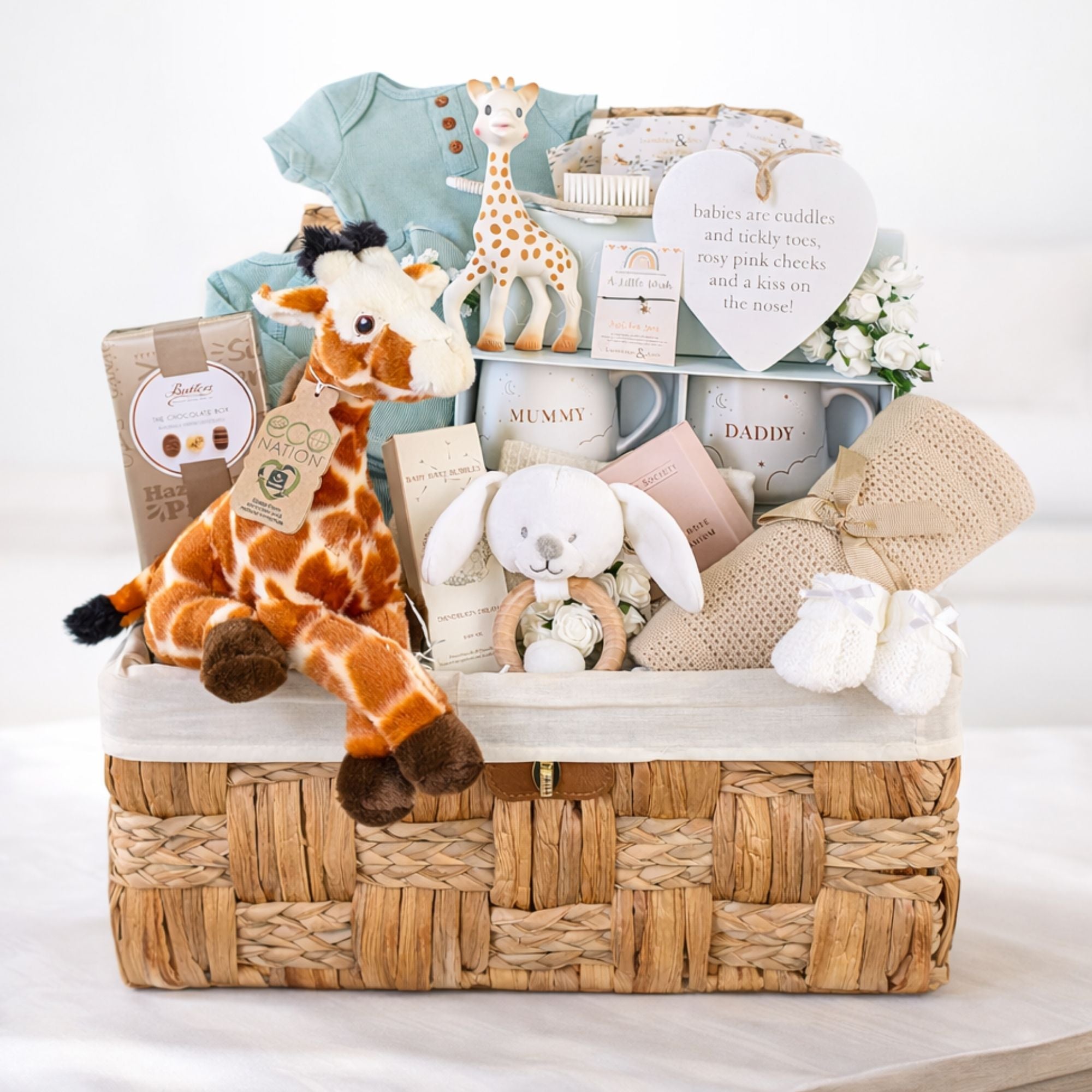 Large gift for a new mum with mug set and a giraffe for baby plus sage green baby clothing and chocolates