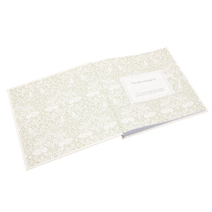 Memories photo album open at decorative floral endpapers