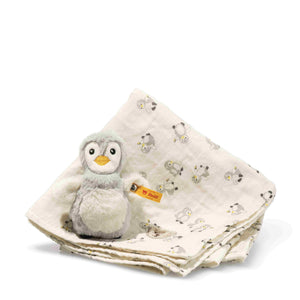 Cream penguin-print burp cloth folded beneath the soft grey Lio penguin grip toy.