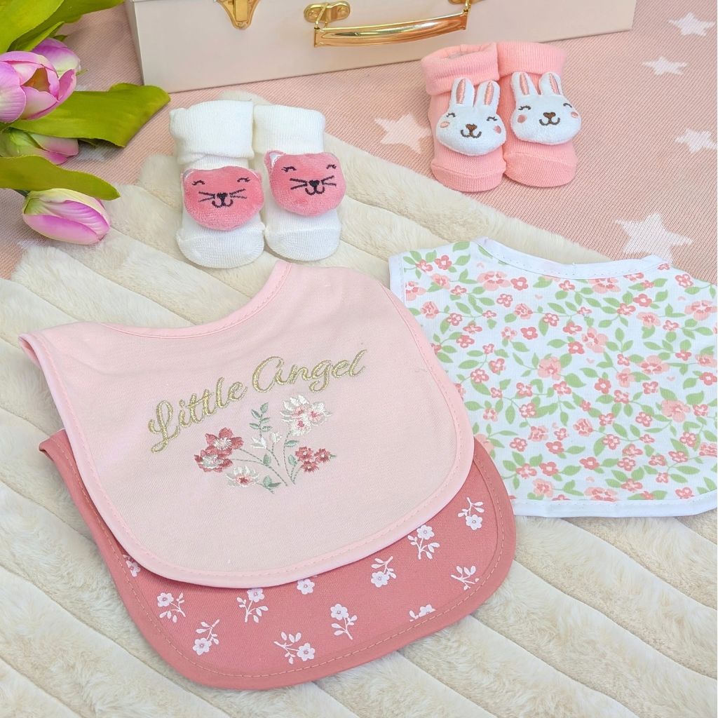 Selection of pink and white baby girl bibs and socks as a matching set.