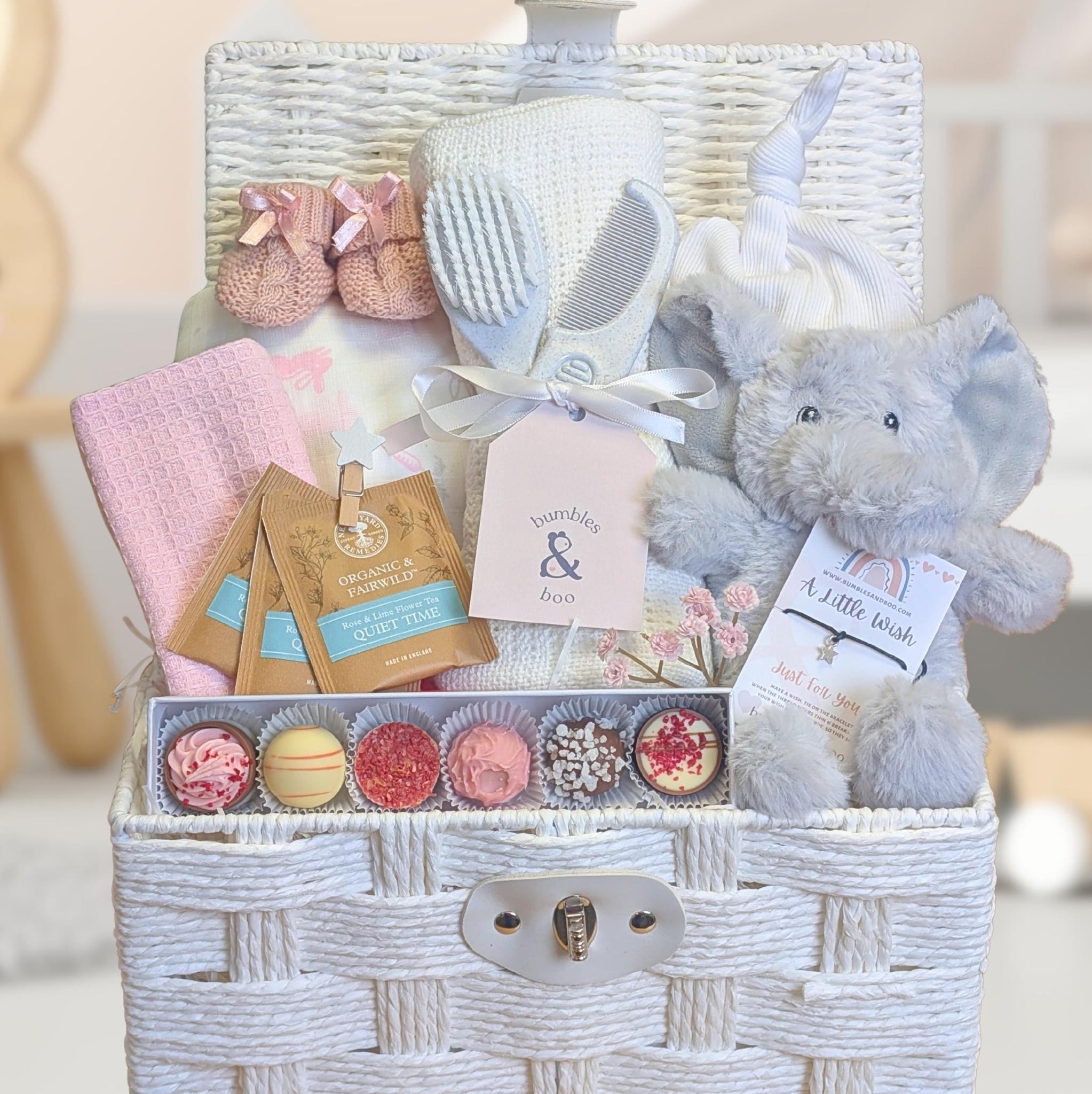 new mum gift basket with chocolate and treats for mum plus a grey cuddly elephant for baby.