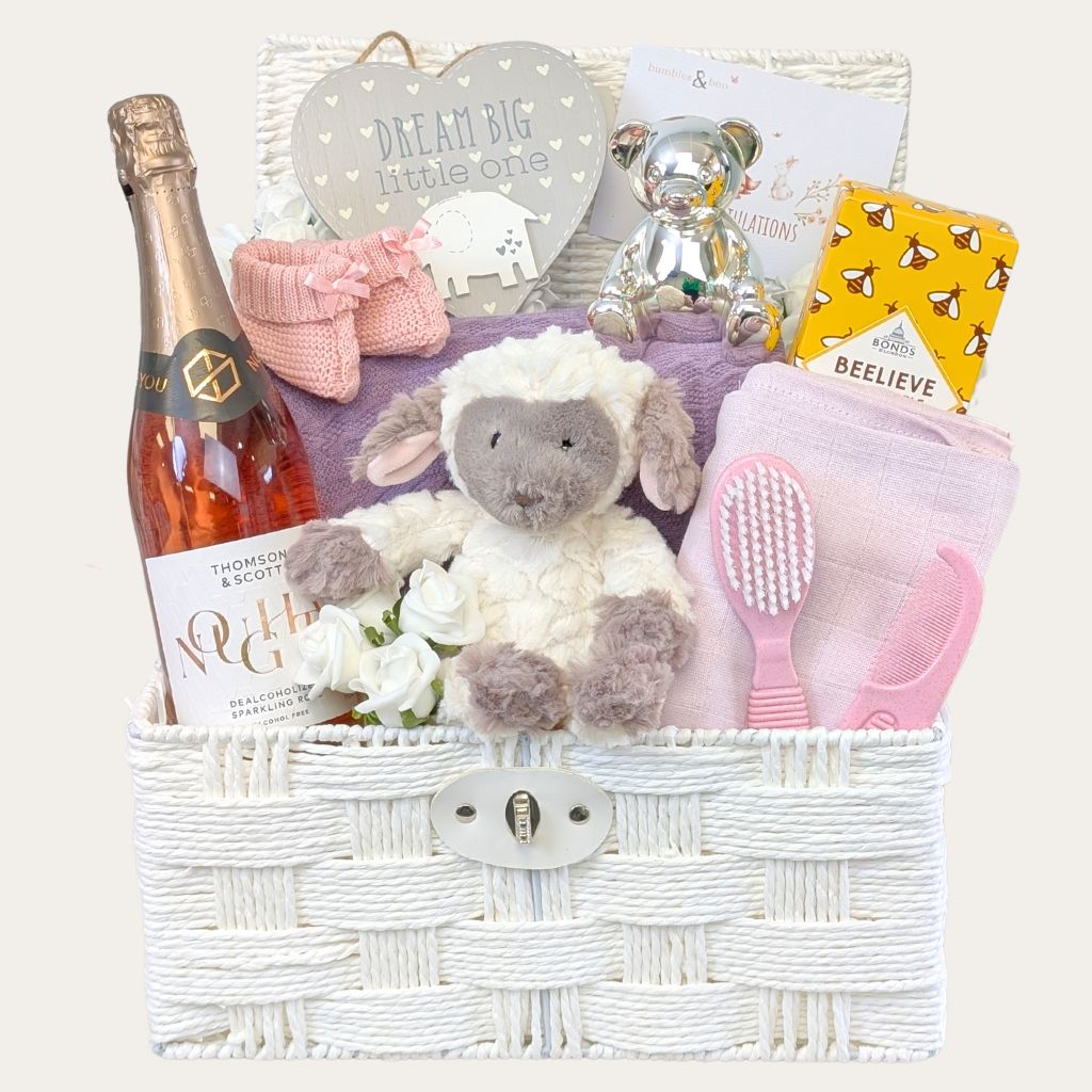 Luxury new mum gifts hamper full of presents in a white basket. With food drink and baby essentials by Bumbles and Boo.