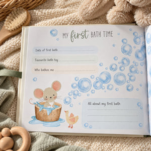 An open baby keepsake journal or photo album page titled 'My first BATH TIME' with lined spaces for writing