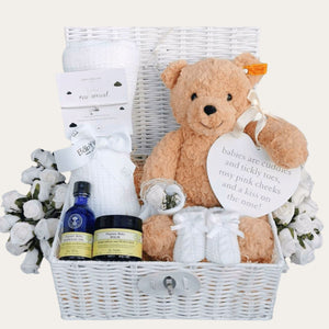 New baby gifts hamper basket with steiff teddy bear, blanket, skincare and bracelet for mum. Bumbles and Boo.