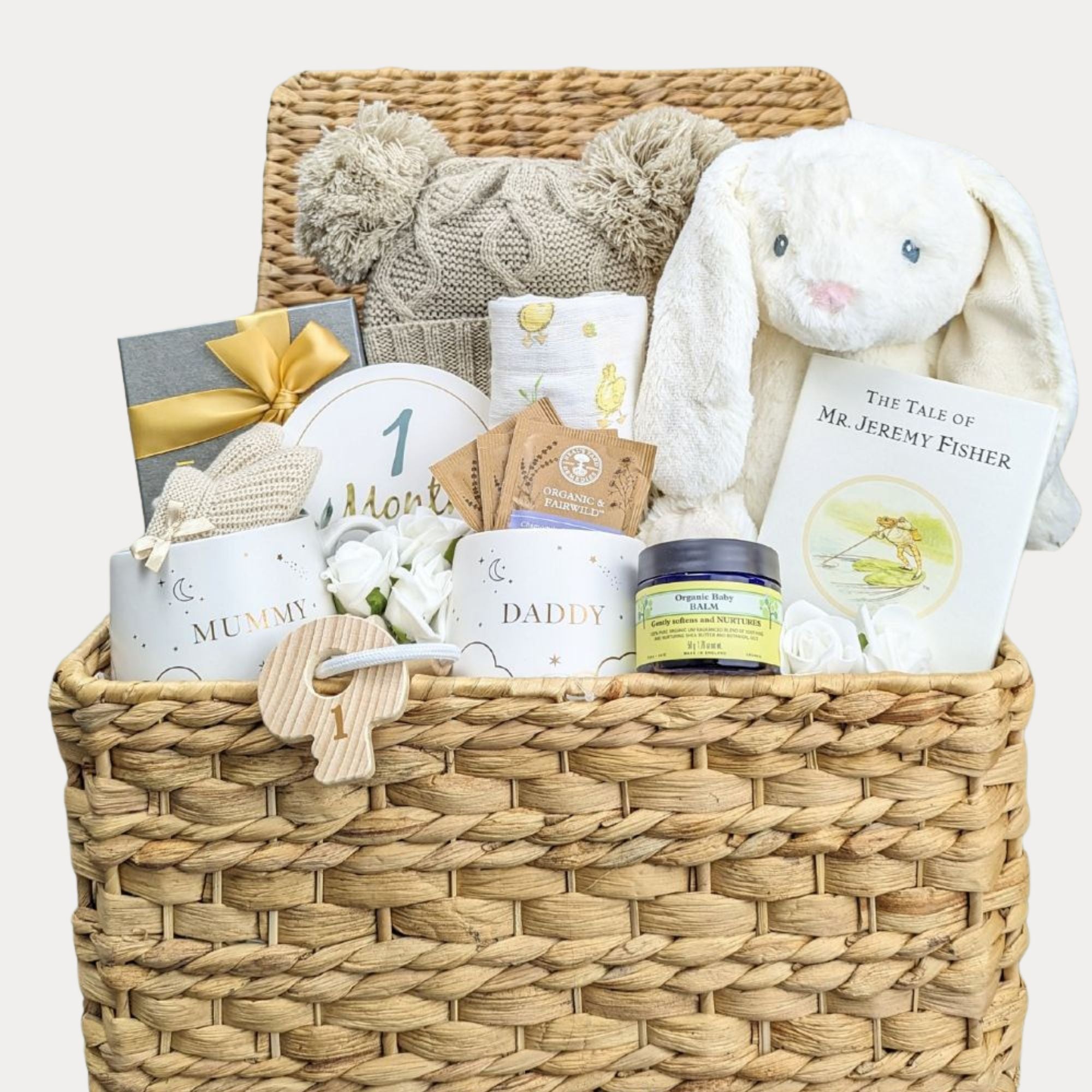 New mum gifts in an adorable hamper basket. Includes chocolate for the new parents.