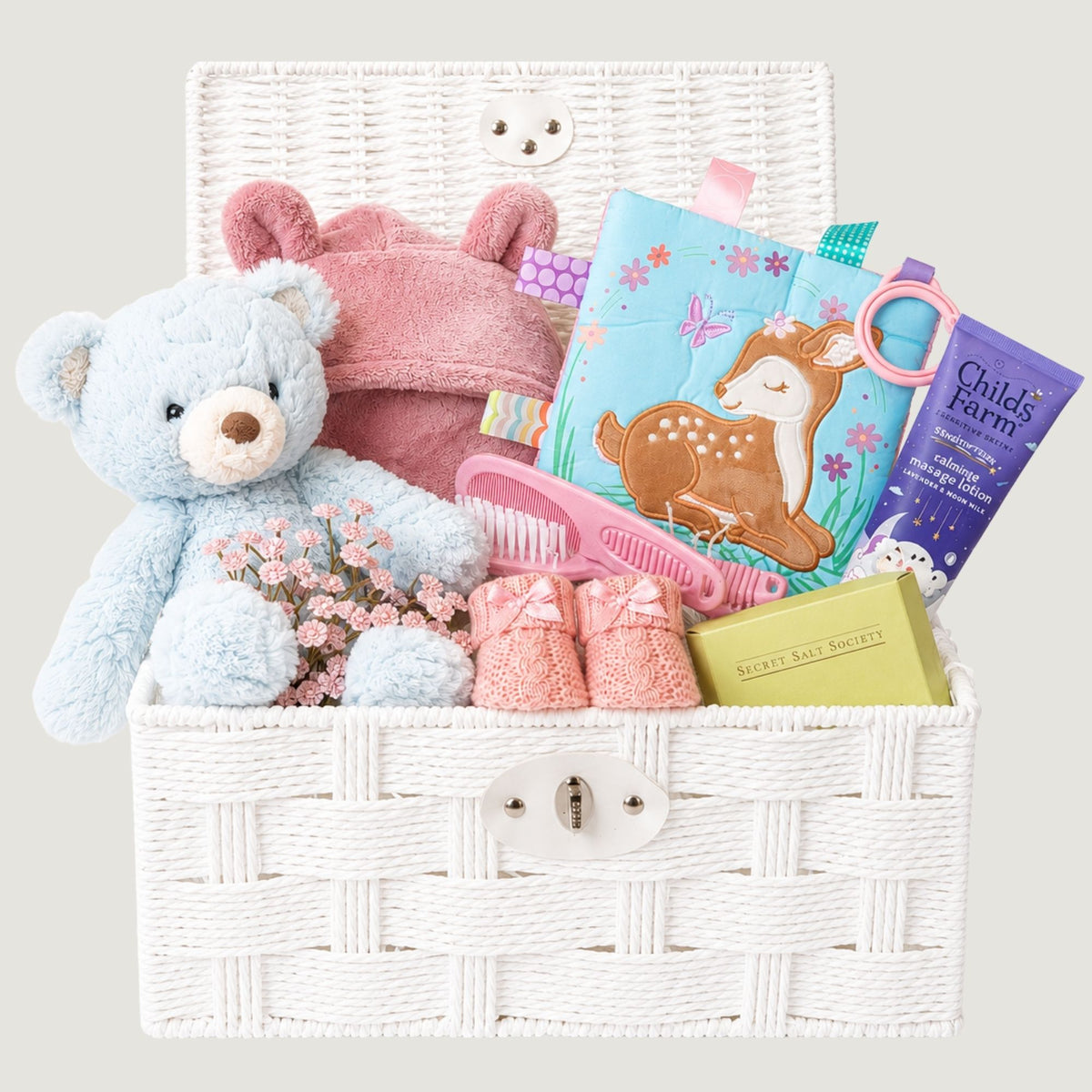 Baby girl gifts hamper basket containing a teddy bear, dressing gown and pink baby presents in a keepsake basket, with other baby essentials.