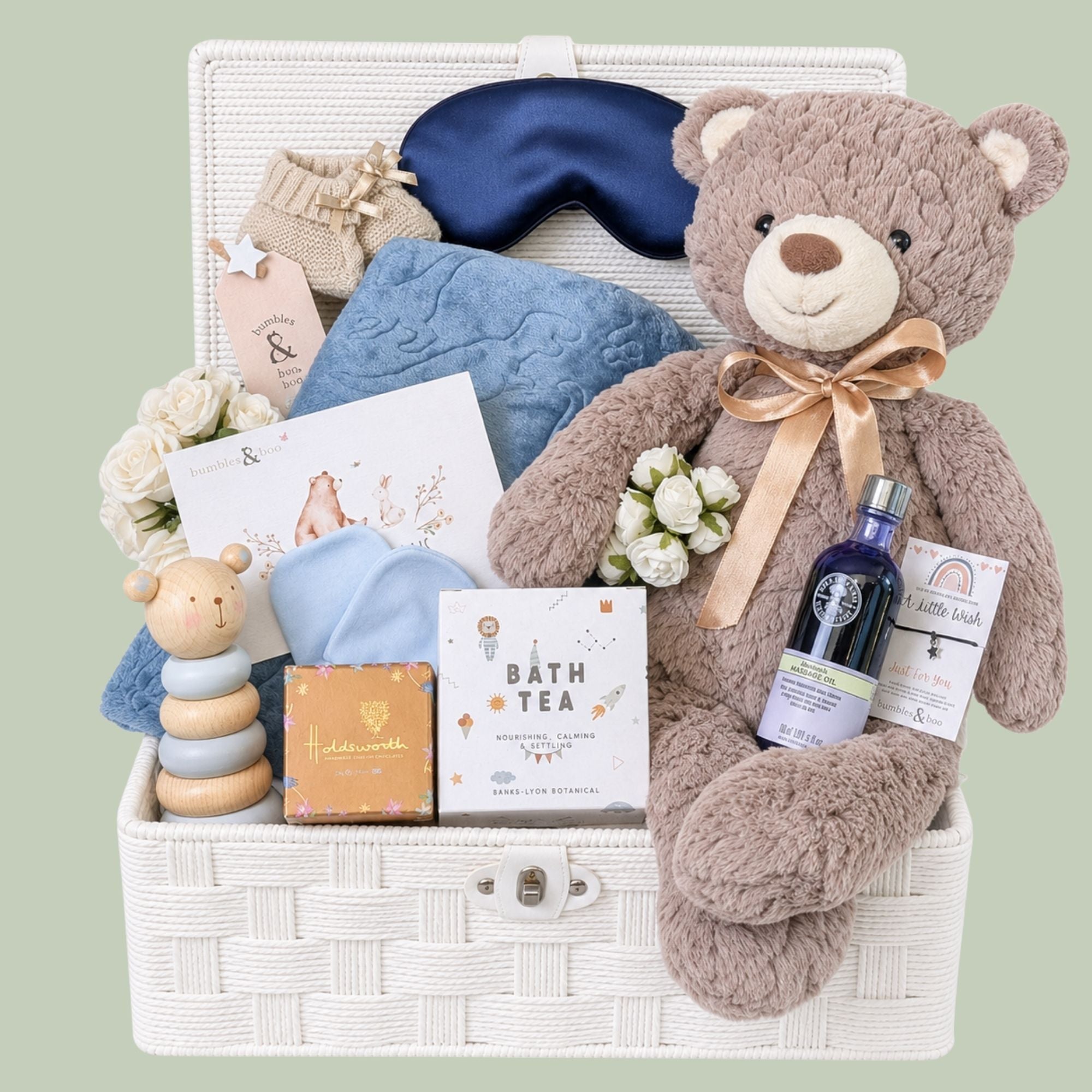 New mum hamper basket brimming with luxury gifts including Neals Yard skin care, large teddy and chocolates.