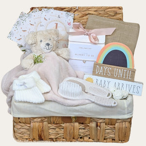 Mother to be hamper gifts in a wicker basket with countdown chalkboard, mummy to be silver bracelet and baby essentials