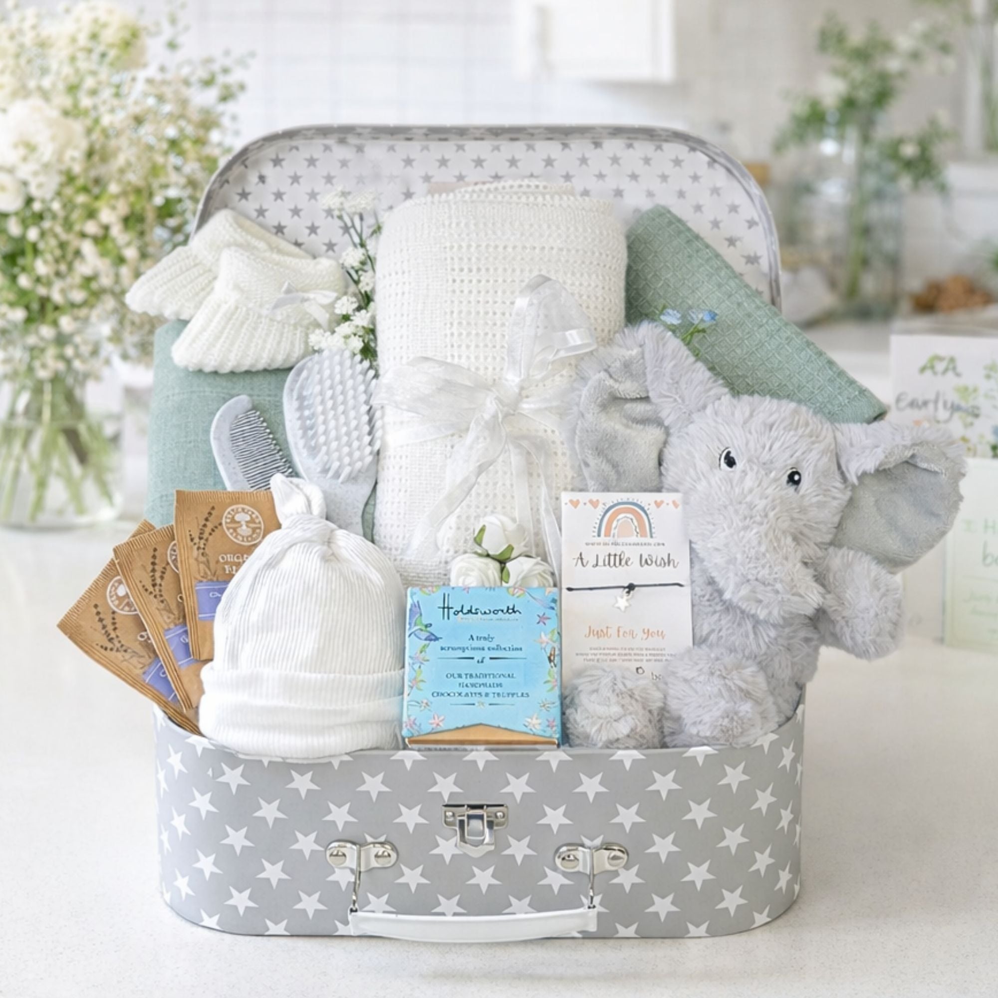 New mum hamper with presents for baby and chocolates for the new mother.