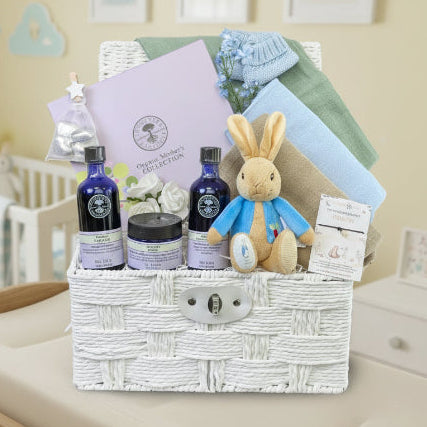 Luxury mum to be gifts basket filled with pampering presents including organic Neals Yard Mothers Skincare Collection. All packed in a white hamper by Bumbles and Boo.
