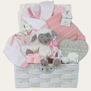 Mum to be hamper in soft pinks and creams featuring gifts including lamb soft toy.