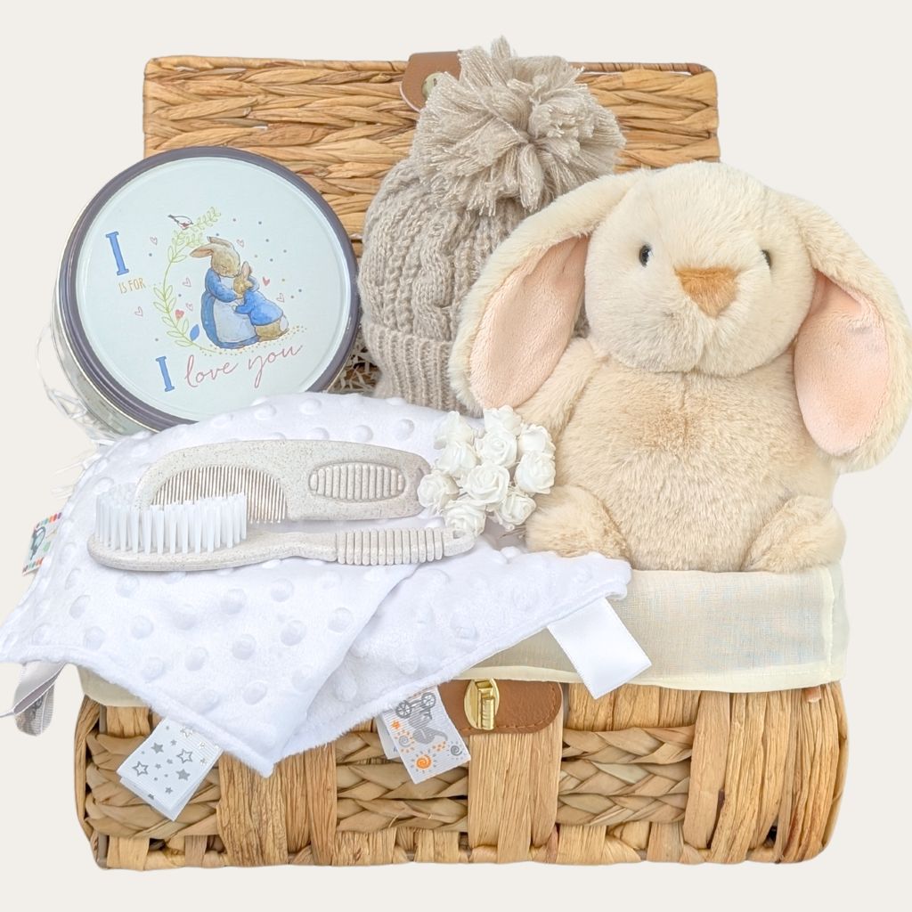 Mum to be gifts hamper with Peter Rabbit biscuit tin, baby hat, soft toy, and newborn essentials