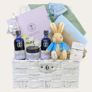 Mum to be gifts hamper basket with Neal's Yard Organic Mother's Collection, muslin squares and Peter Rabbit toy.