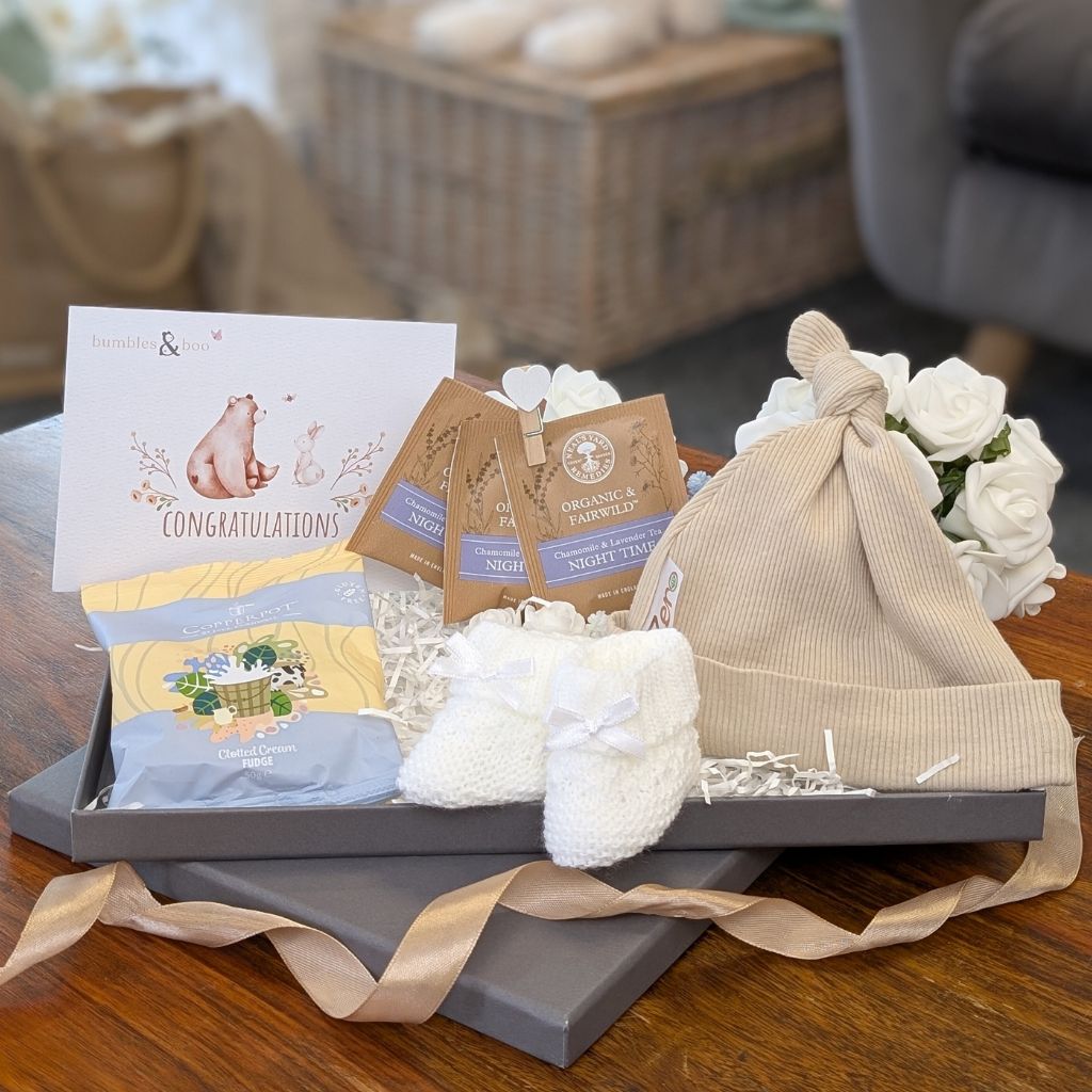 Mum to be letterbox gift with presents including beige baby essentials, fudge and tea