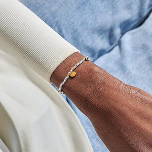 Gold and silver Mummy To Be Bracelet worn on the wrist