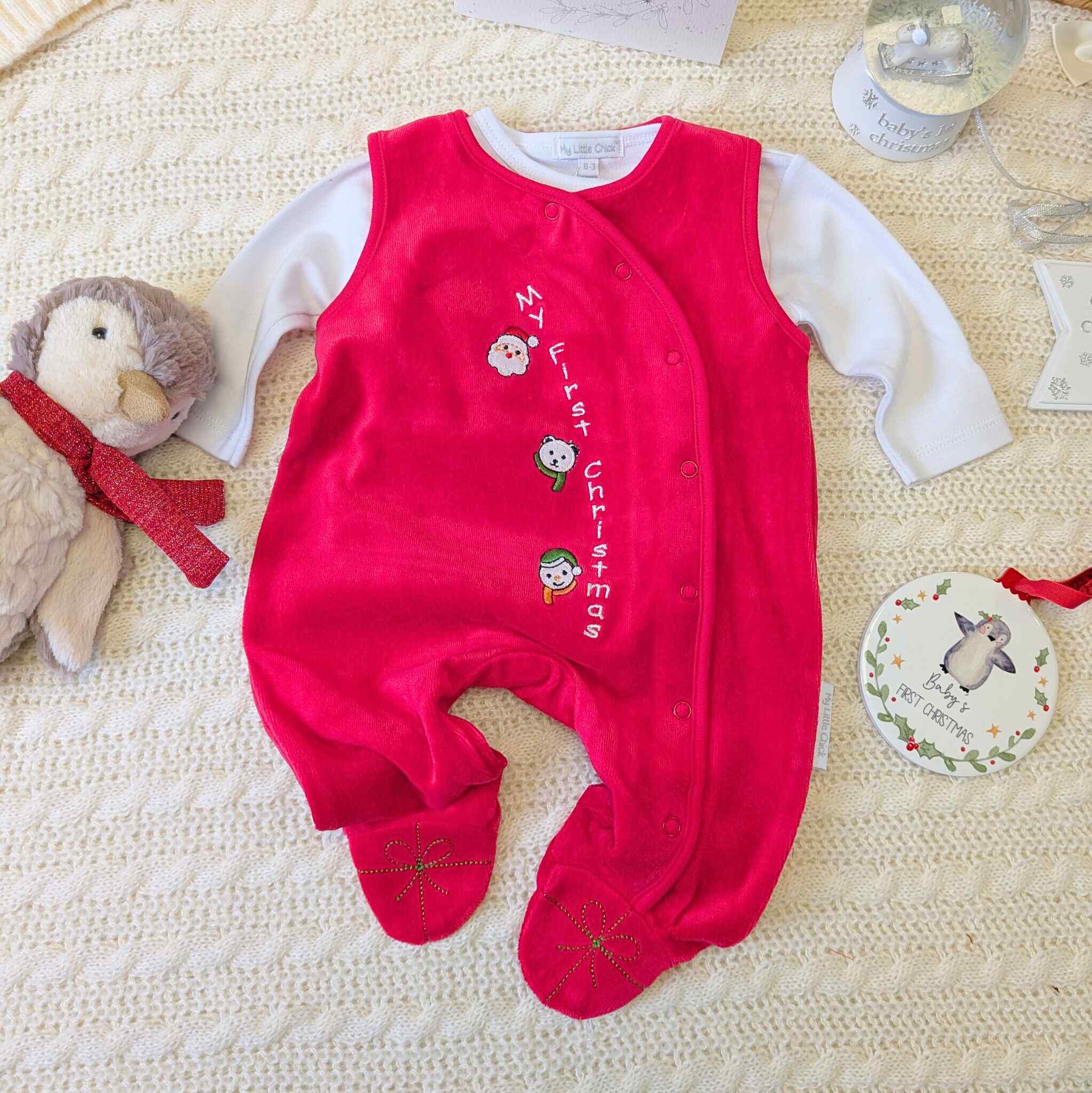 Red baby romper which reads My First Christmas