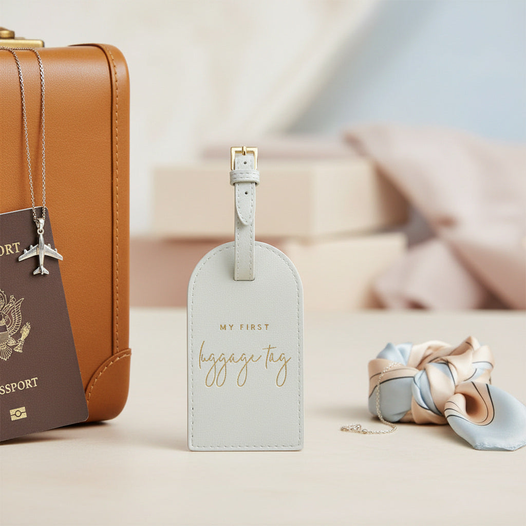 Blue vegan leather My First Luggage Tag with gold buckle and stitched edge, travel accessory from Katie Loxton.
