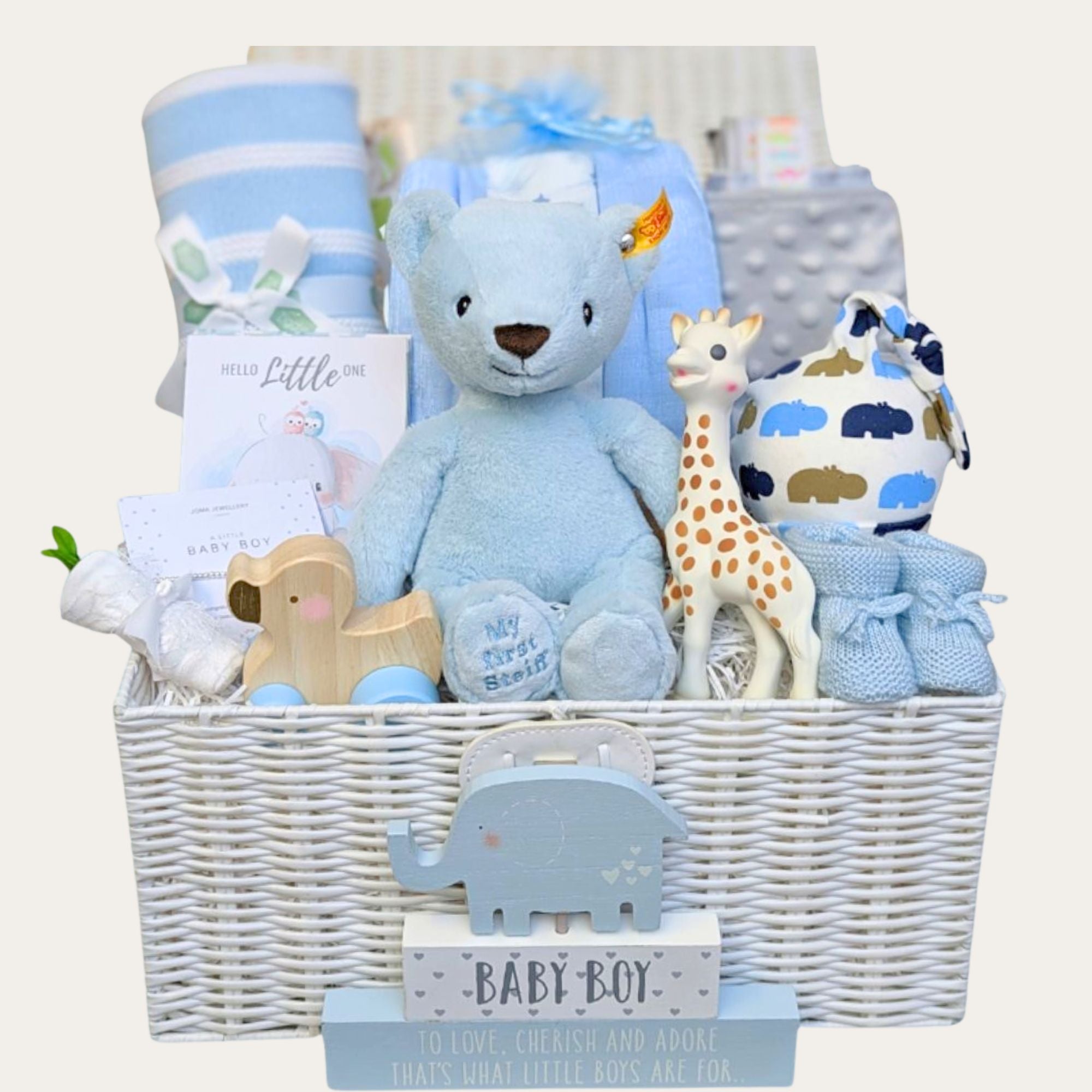 Baby boy gifts hamper basket with blue steiff bear, blanket, sophie la giraffe and more presents by Bumbles and Boo.