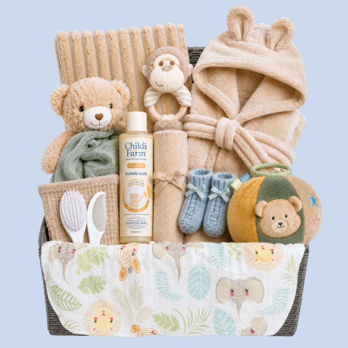 Large baby boy gifts hamper with presents including beige dressing gown, teddy comforter and sensory toys.